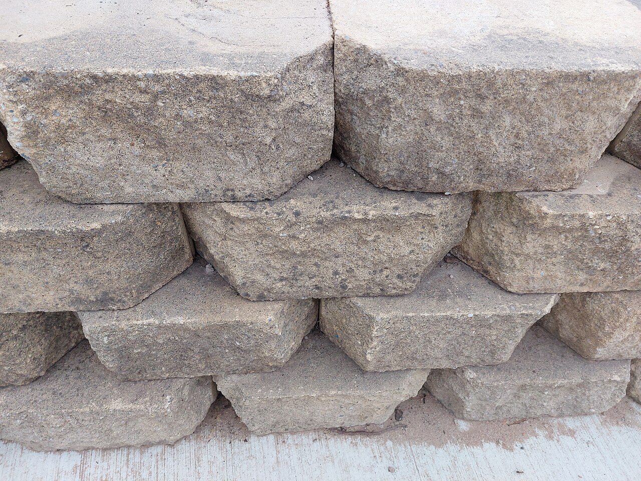 Close-up of stacked split-face retaining wall block courses